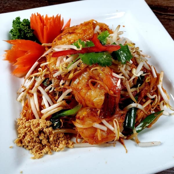 A plate of Urban Thai & Sushi's Pad Thai with shrimp, bean sprouts, and crushed peanuts.